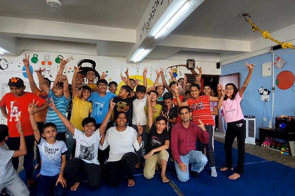 Group of happy students posing with Devanshi Mam at Jump-N-Rise, showcasing a lively and active environment in their fitness class.