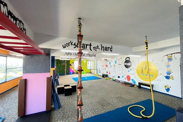 Colorful kids gym interior at Jump-n-Rise with playful wall art.